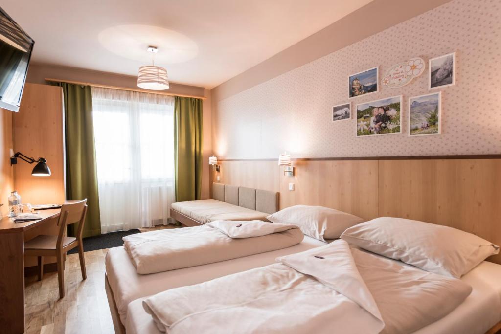 Ein Bett oder Betten in einem Zimmer der Unterkunft JUFA Hotel Grundlsee