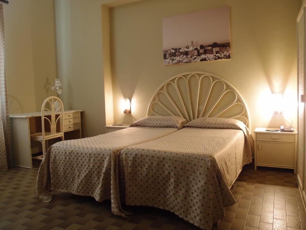 Postel nebo postele na pokoji v ubytování Pietra Pomice Hotel