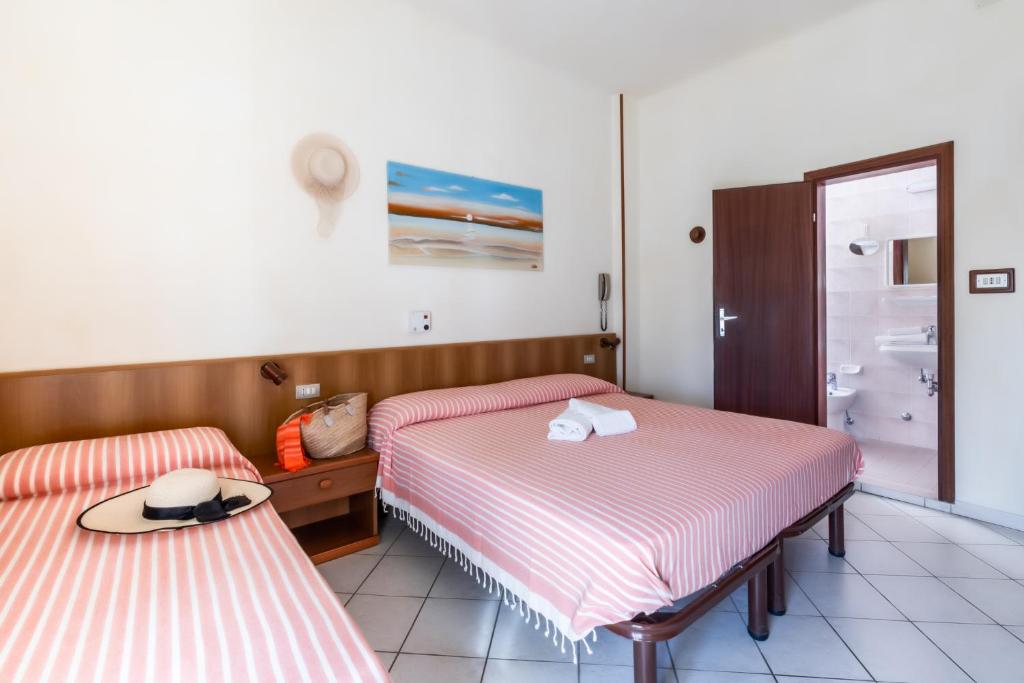 Postel nebo postele na pokoji v ubytování Albergo Rosa & Cosetta