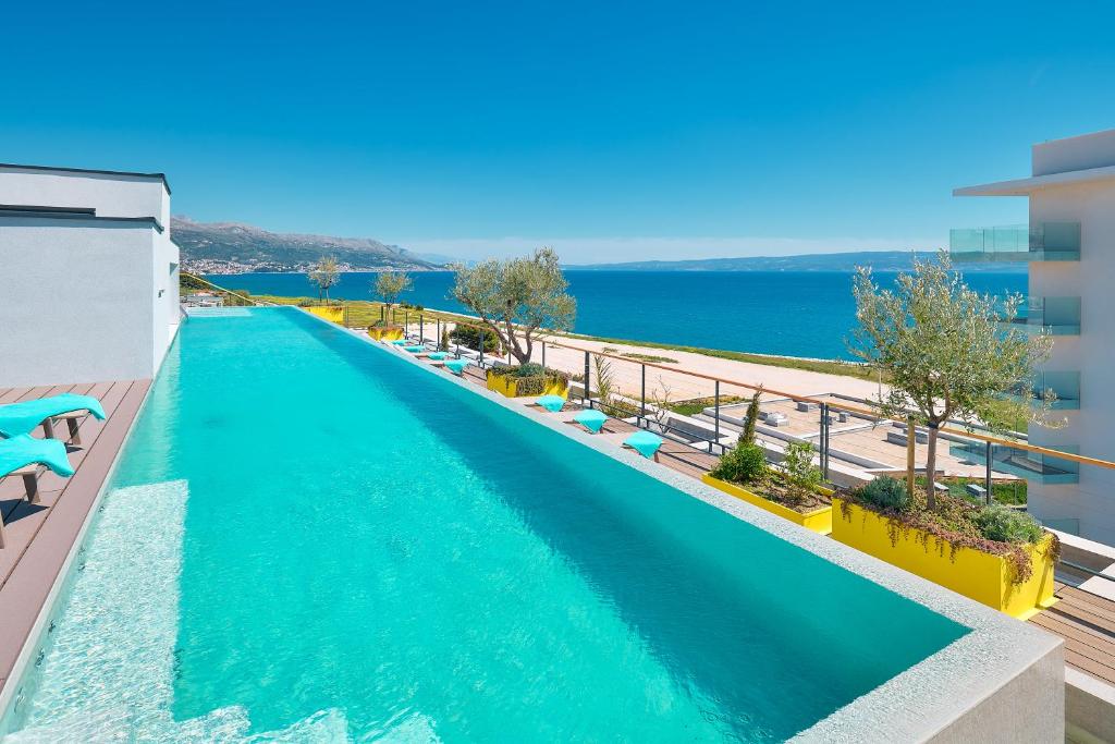 a swimming pool with a view of the ocean at Amphora's Garden in Split