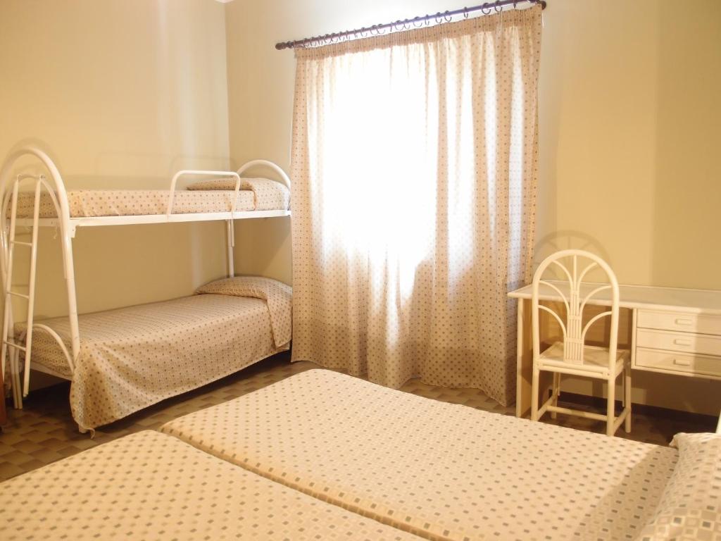 Postel nebo postele na pokoji v ubytování Pietra Pomice Hotel