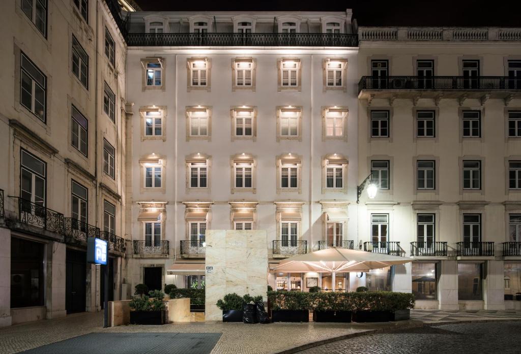 a large white building with an umbrella in front of it at AlmaLusa Baixa/Chiado in Lisbon