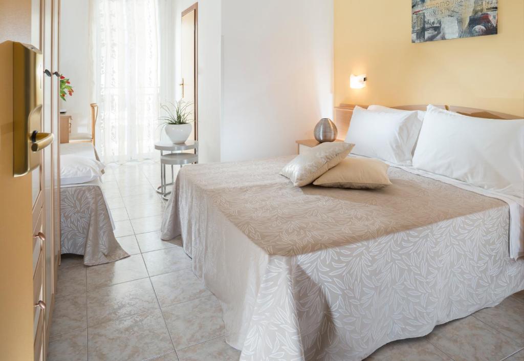 Postel nebo postele na pokoji v ubytování Hotel Bellerofonte