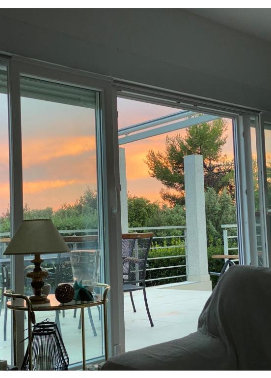a room with a sliding glass door with a view of a patio at Seaside House PuntaSkala in Petrcane