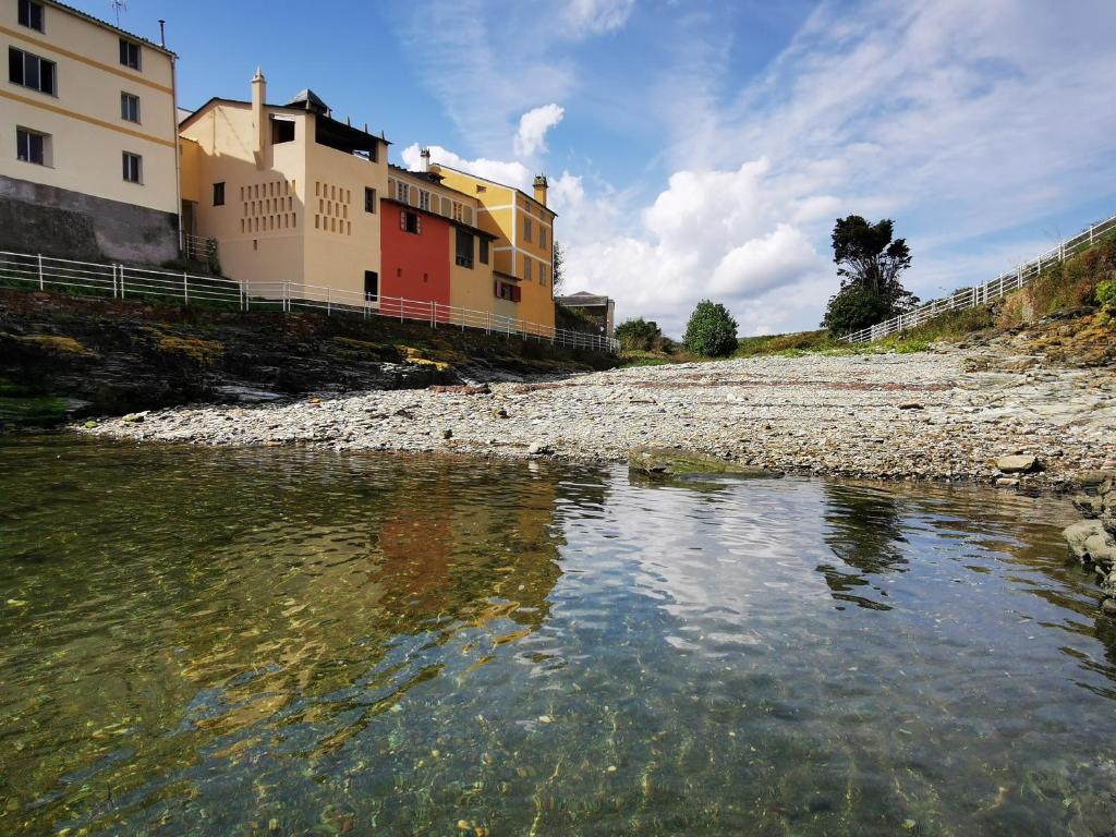 麟洛的住宿－Belvedere with sea views，一条河,在水边的小山上建有建筑物