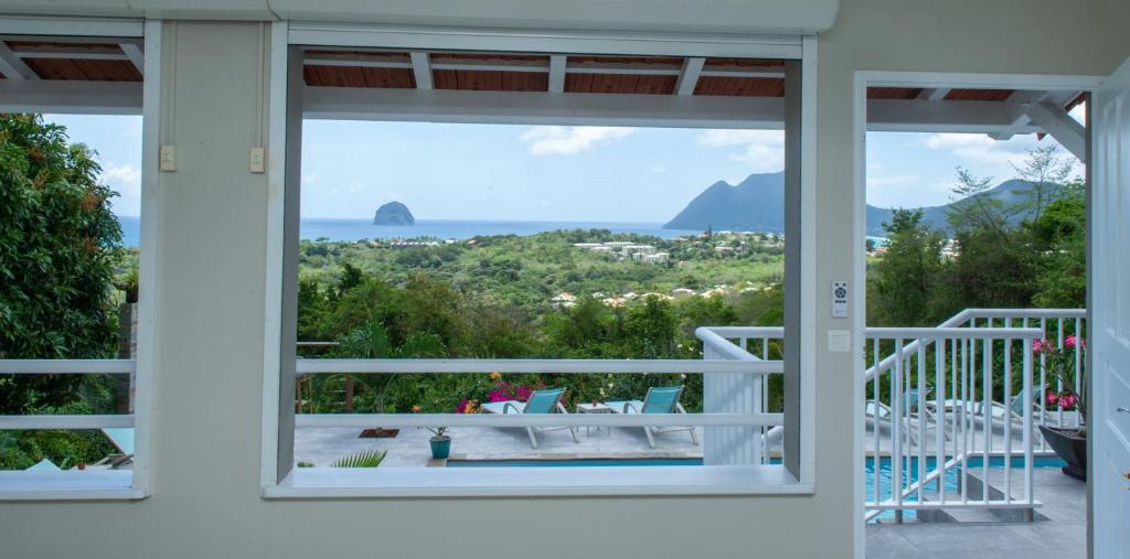 a view from the window of a house at Kaz O'Rocher - Sea View Appartements in Le Diamant