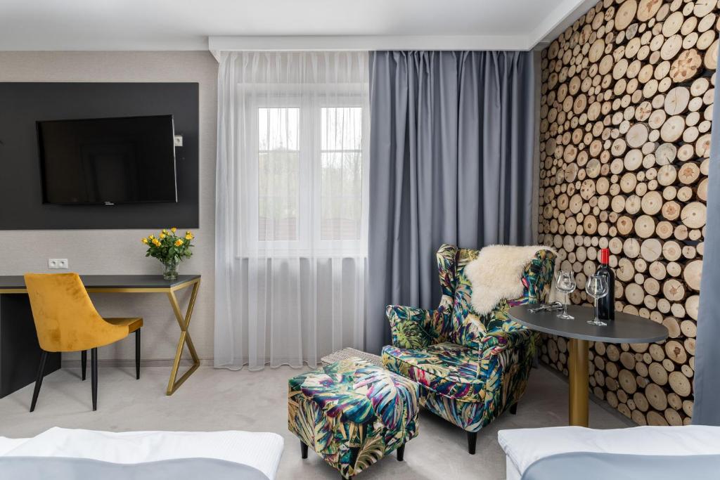 a living room with a chair and a table at Zamkowe Apartamenty in Sandomierz