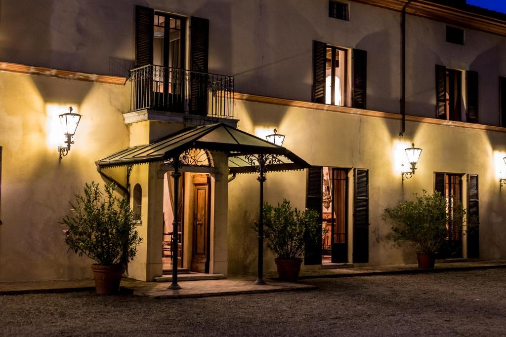 a building with a gazebo in front of it at night at Villa Dom in Piacenza