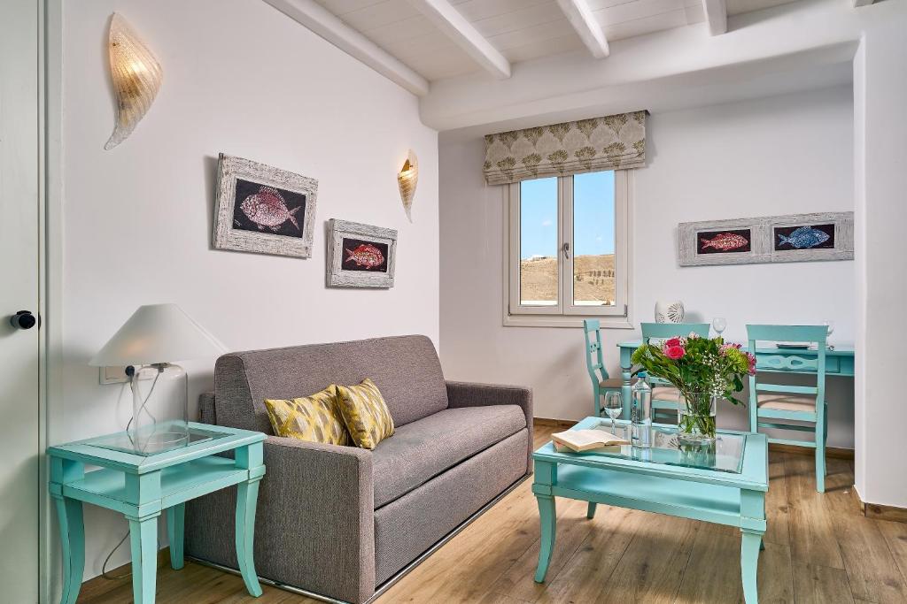 a living room with a couch and two tables at Arte & Mare Elia Luxury Suites and Villas in Elia Beach