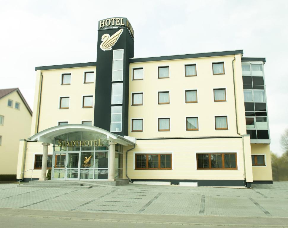 a building with a sign on top of it at Stadthotel Giengen in Giengen an der Brenz