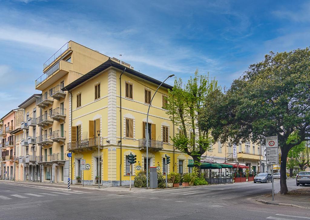 a yellow building on the side of a street at Villa Grazia in Viareggio