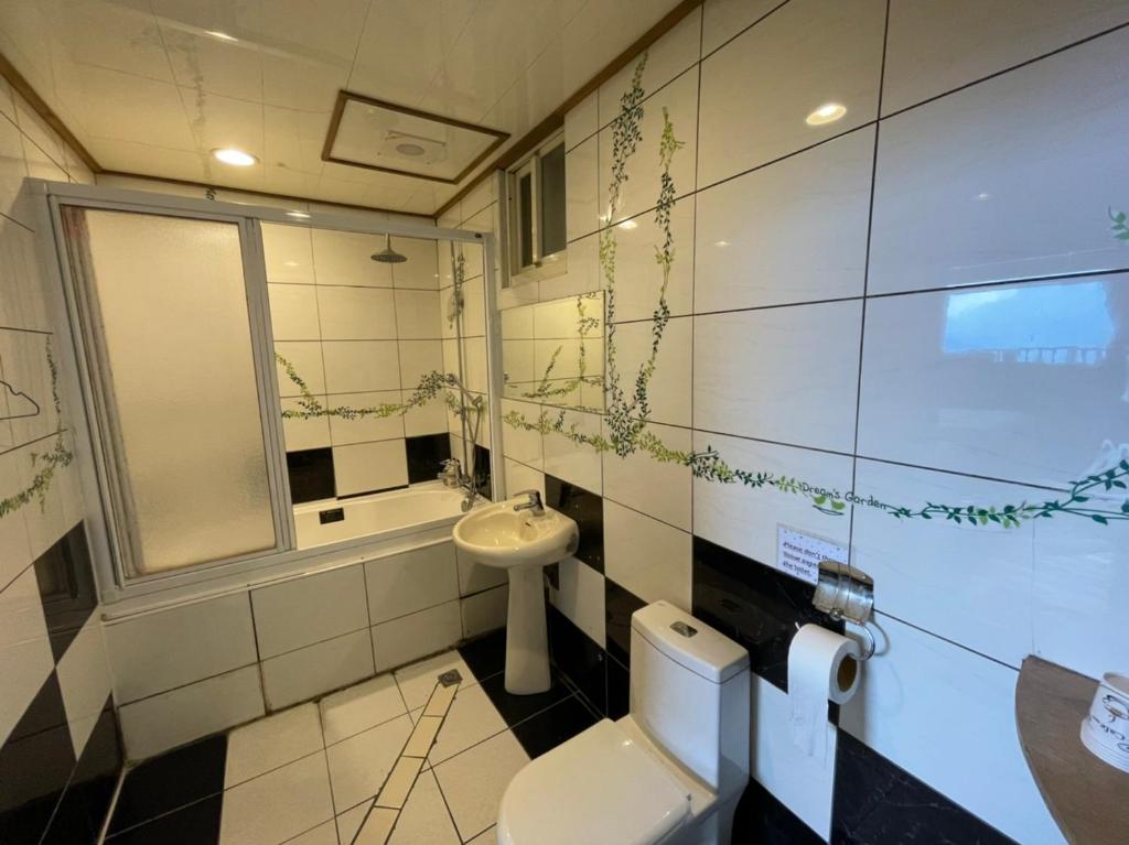 a bathroom with a toilet and a sink at Emmanuel Farm House in Ren&#39;ai