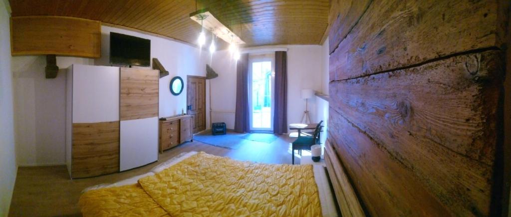 a bedroom with a bed and a wooden wall at kajakshop-wildalpen in Wildalpen