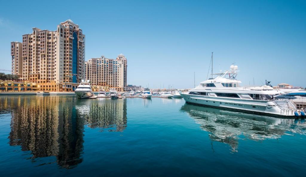 a group of boats docked in a harbor with buildings at Maison Privee - Tiara Diamond G06 in Dubai