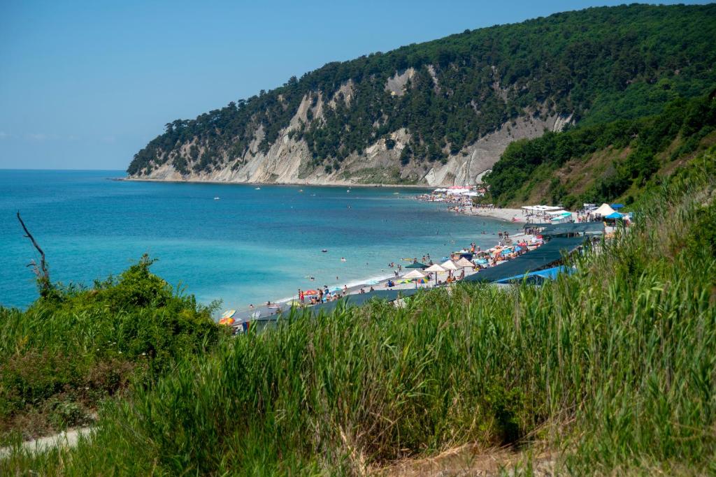 a beach with a bunch of umbrellas and the ocean at Villa Alla in Inal