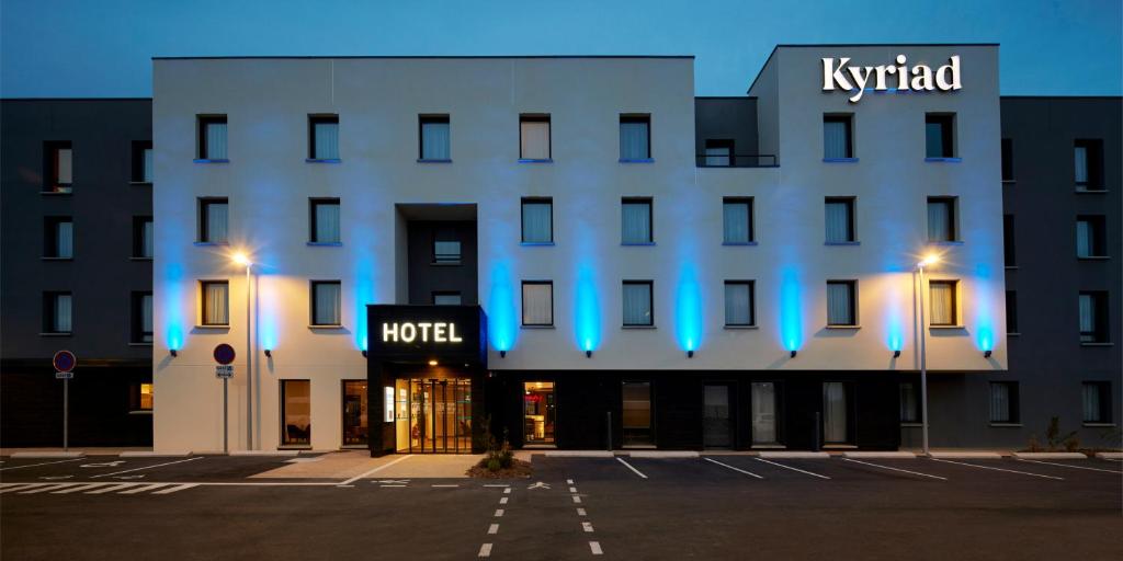 a hotel with blue lights on the front of a building at Kyriad Combs-La-Ville - Senart in Combs-la-Ville