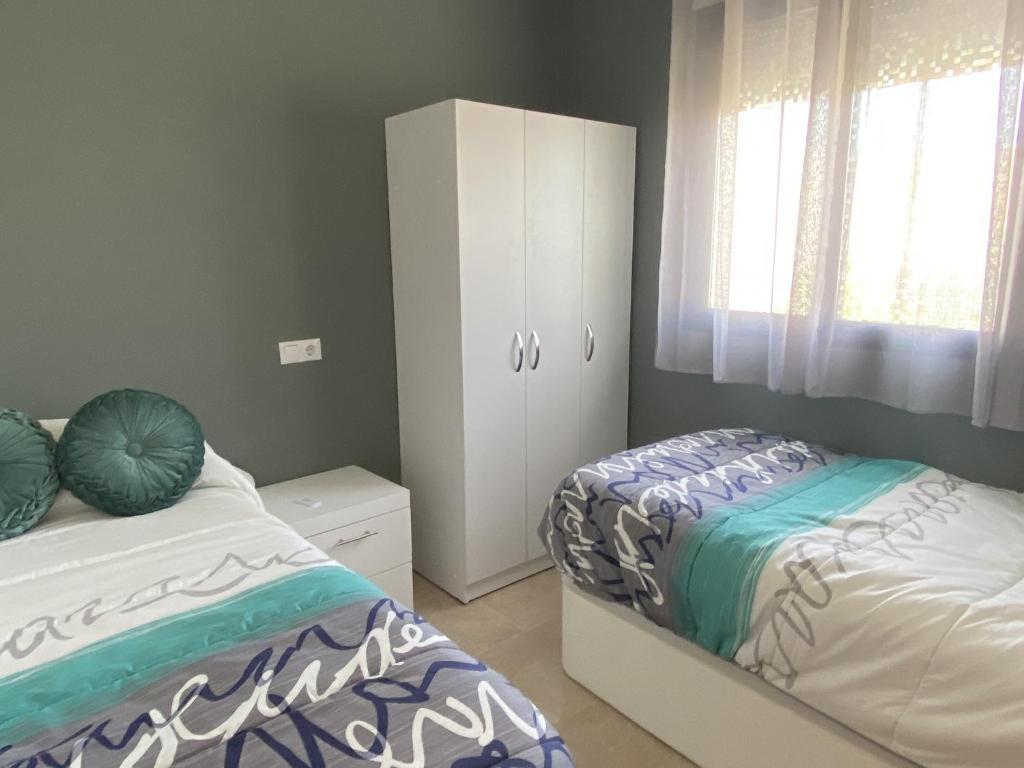 Posteľ alebo postele v izbe v ubytovaní Apartamento Calypso Inmomart