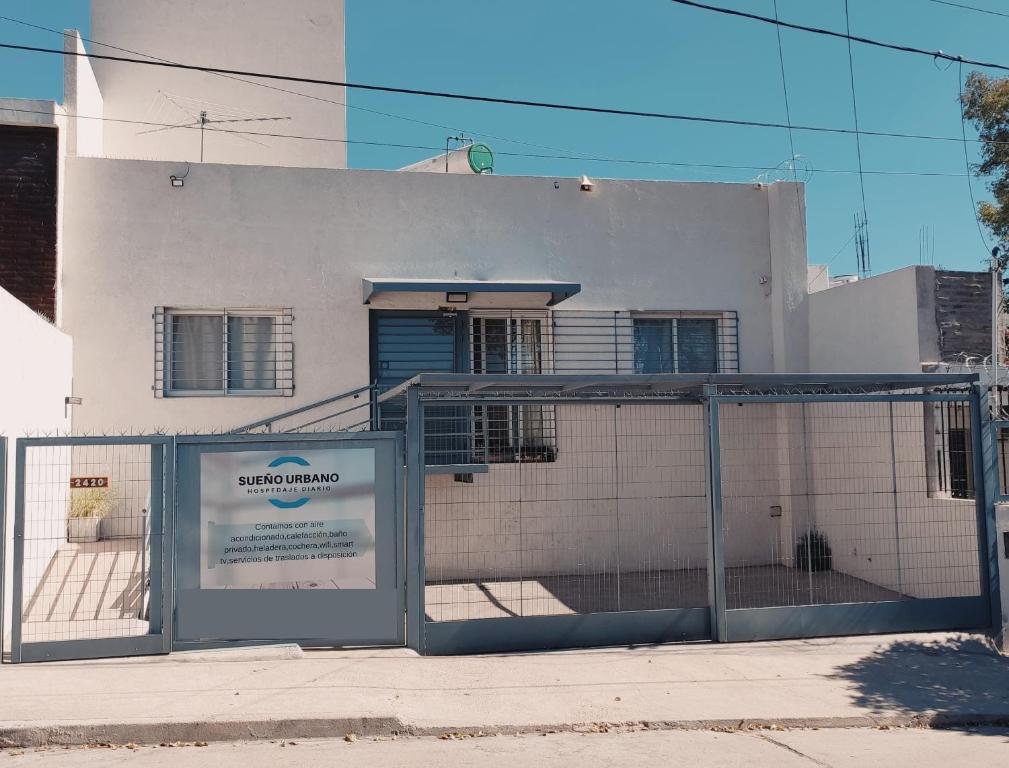 a building with a sign in front of it at Hospedaje SUEÑO URBANO in Córdoba