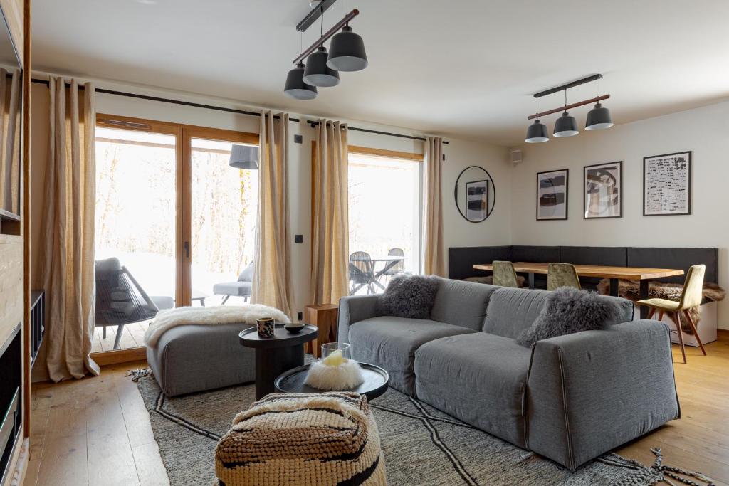 a living room with a couch and a table at Interlude Megeve in Megève