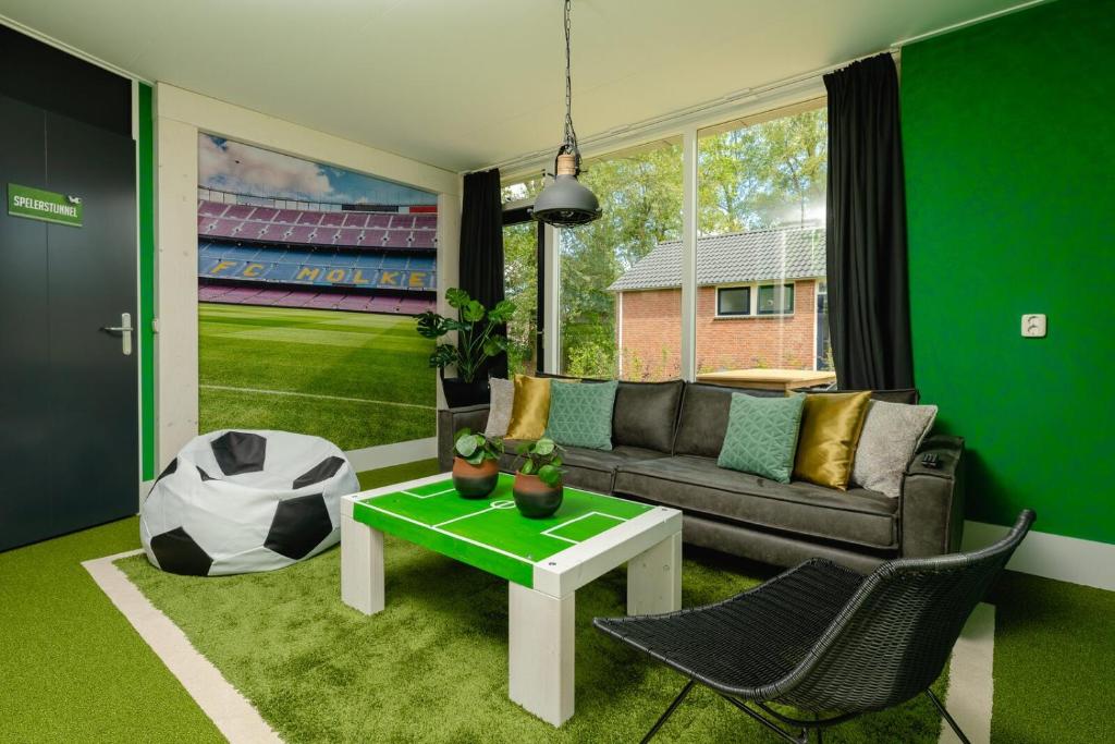a living room with a couch and a table at Child Bungalow FC Mölke Stadium 6 People in Zuna