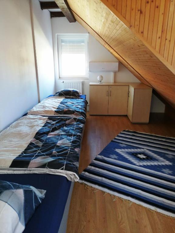 A bed or beds in a room at Szent György Vendégház