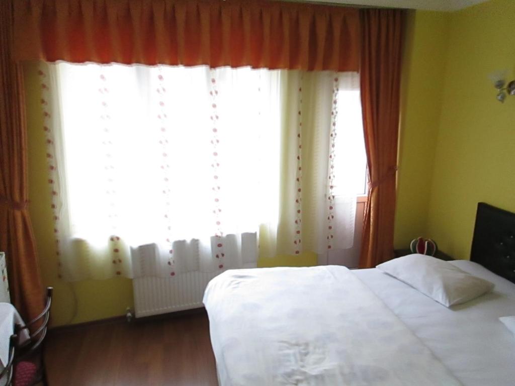 Postel nebo postele na pokoji v ubytování Bereket traveler Hotel