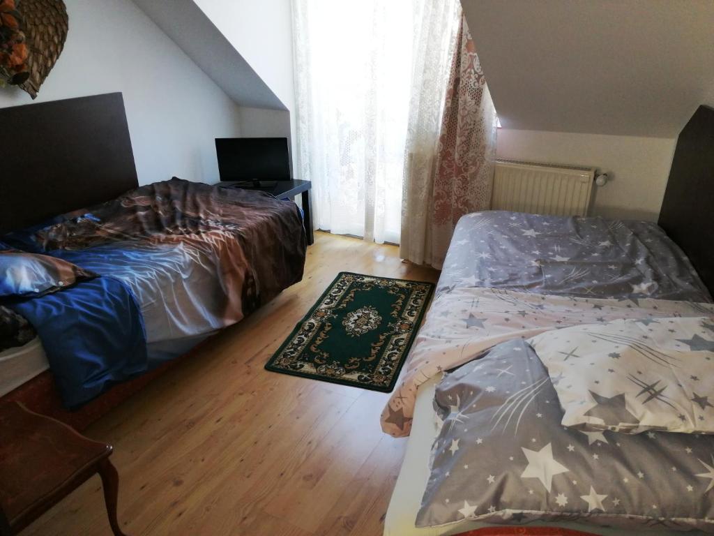 A bed or beds in a room at Szent György Vendégház
