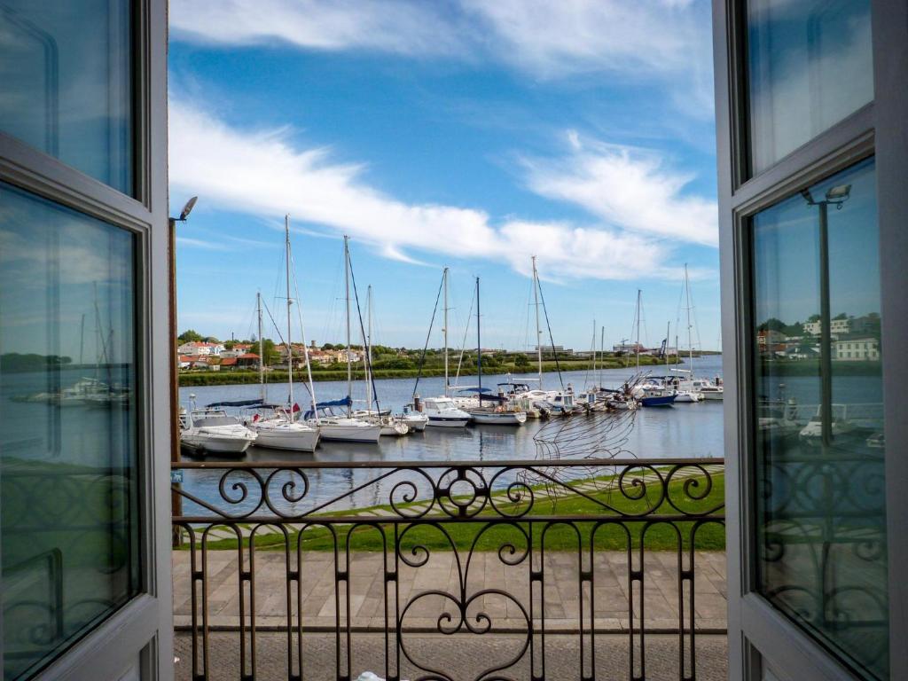 a view of a harbor with boats in the water at Naval Guest House & Bistrô in Vila do Conde
