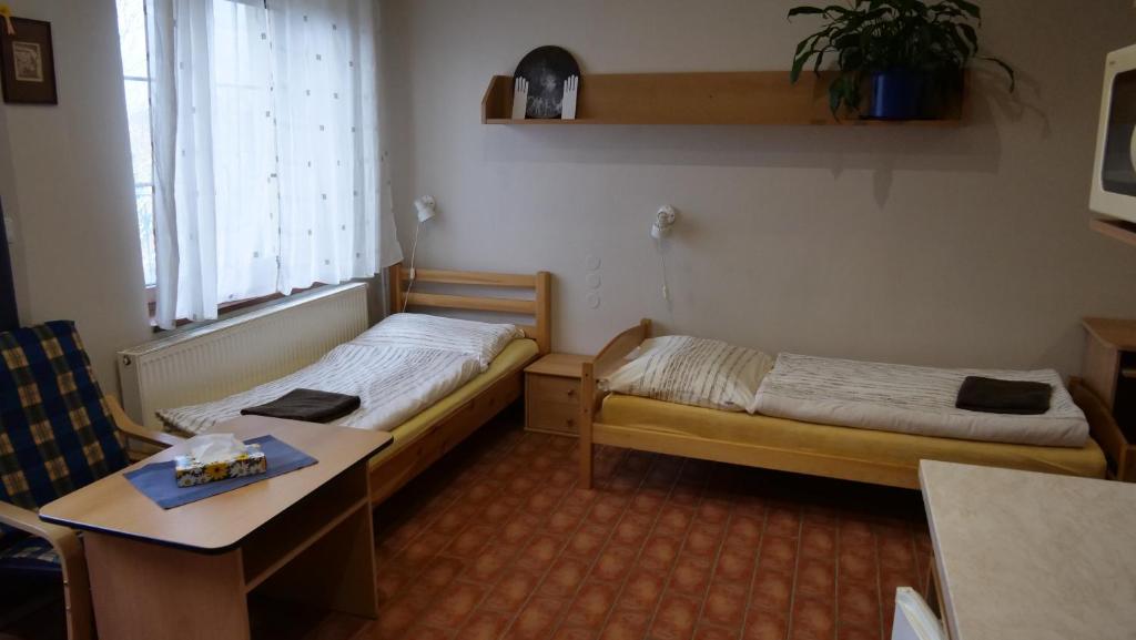 Postel nebo postele na pokoji v ubytování Penzion Na Hradbách