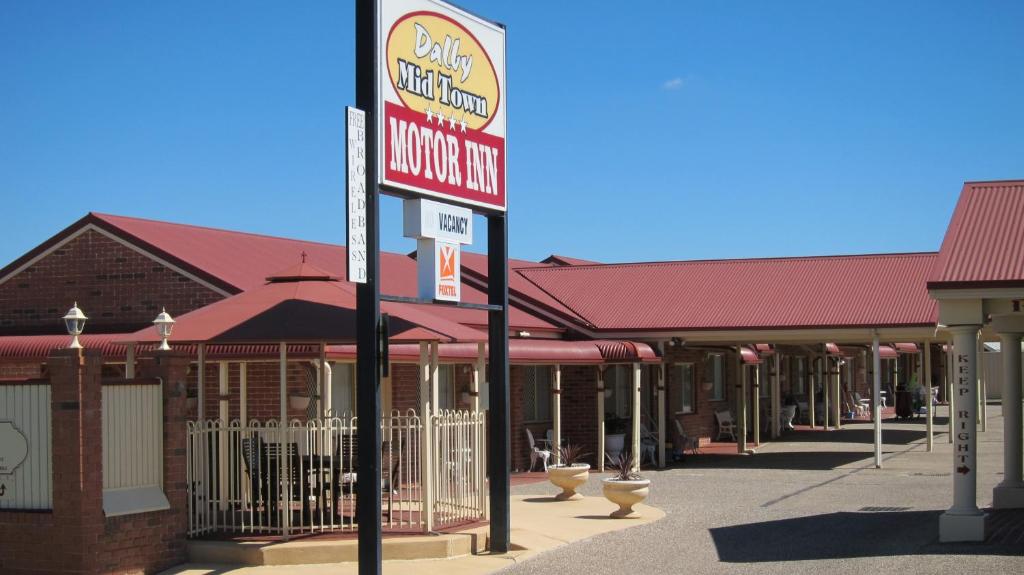 a sign for a mcdonalds restaurant on a street at Dalby Mid Town Motor Inn in Dalby