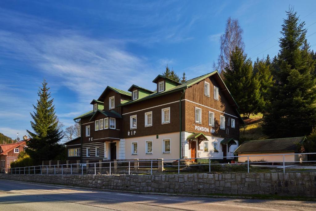 a large house on the side of a street at Pension Říp in Pec pod Sněžkou