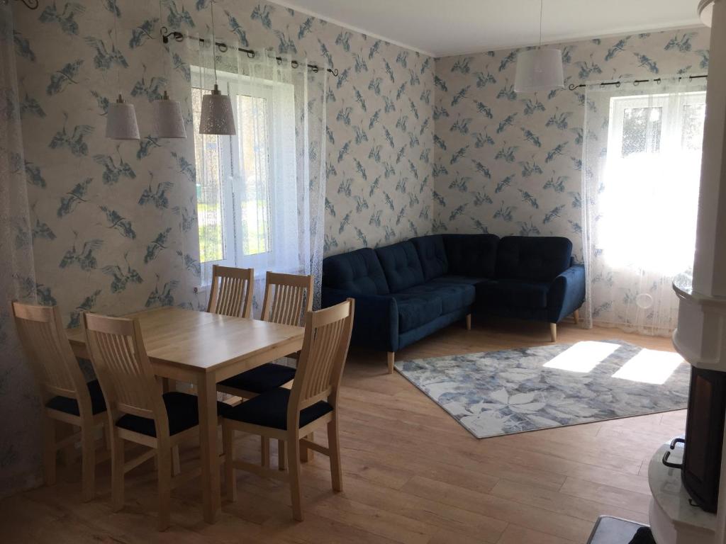 a living room with a table and chairs and a couch at Allika külalistemaja 