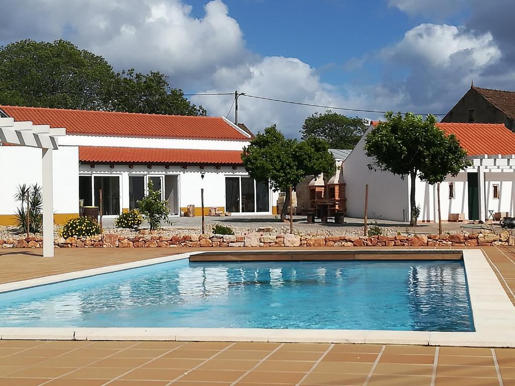 a swimming pool in front of a house at Villa Rominha Alvaiázere - Casa do Canteiro in Alvaiázere