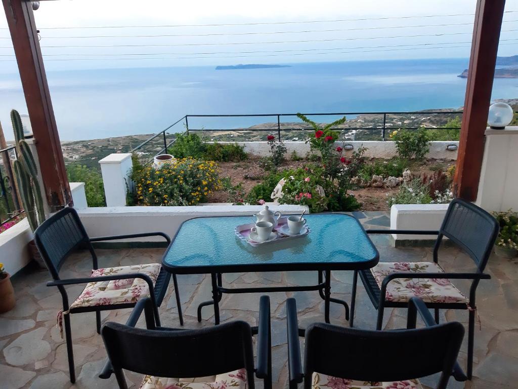a table and chairs with a view of the ocean at Roussa's View Apartments in Sitia