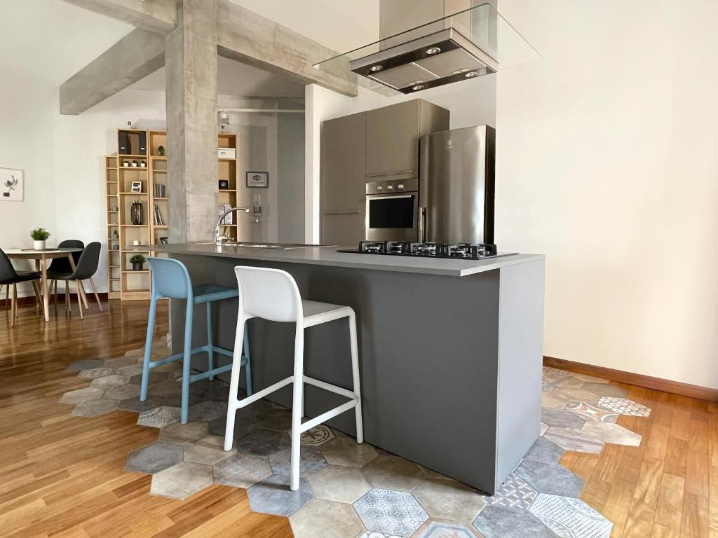 a kitchen with a counter and stools in a room at Vista Reale Apartment in Caserta