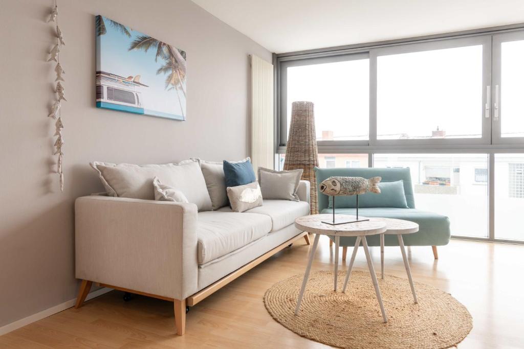 a living room with a white couch and a table at Ko´Ono Hotel in Konstanz