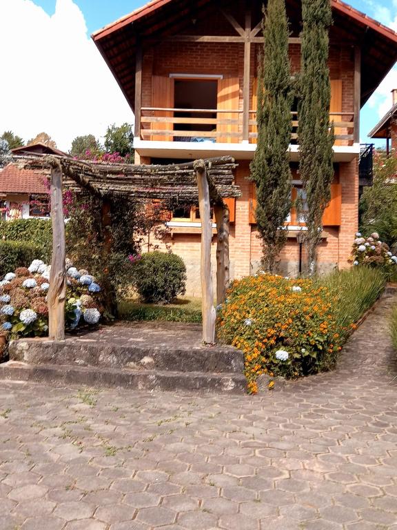a house with a staircase in front of it at Claire Cottage in Monte Verde