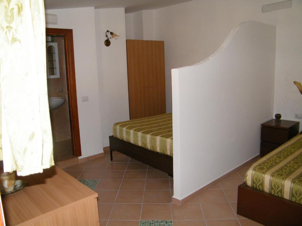 Postel nebo postele na pokoji v ubytování Hotel Villaggio Tabù