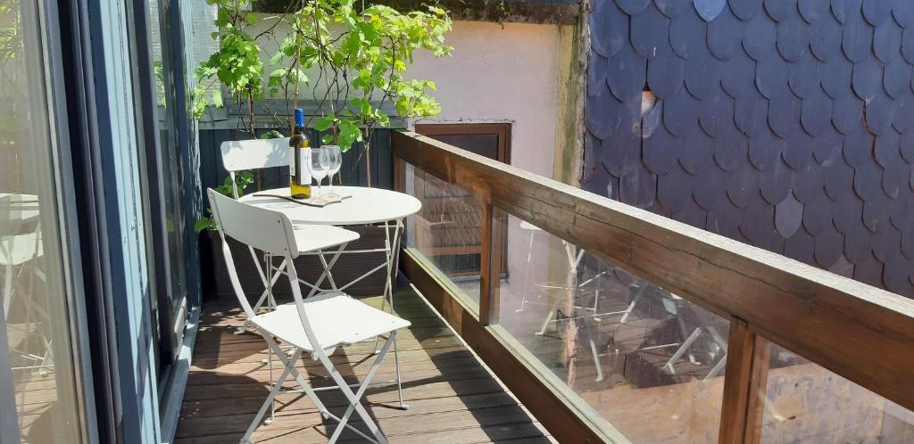 un balcón con una mesa y una copa de vino en Modern house - air cond, free parking, breakfast, en Vila Nova de Gaia