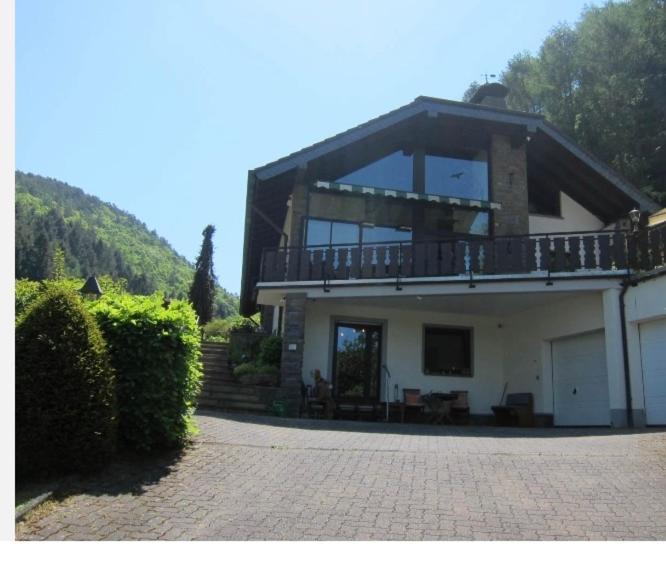 a large house with a balcony on top of it at Ferienappartement WildeAhr in Rech