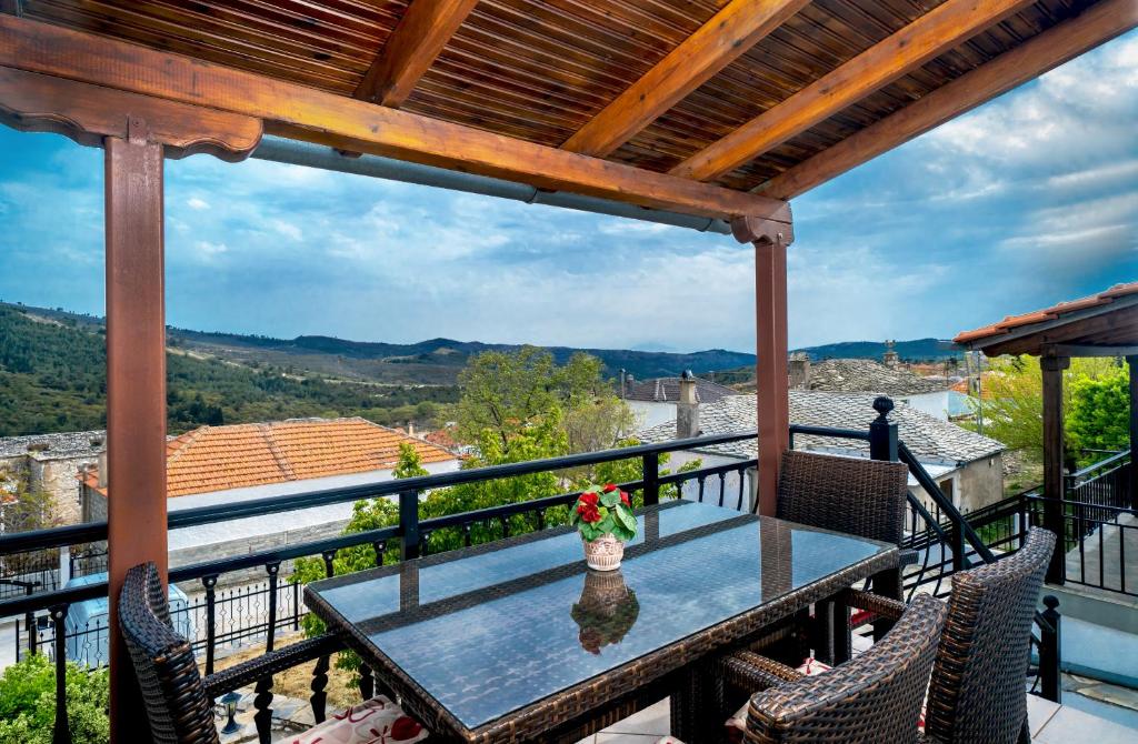 a table and chairs on a balcony with a view at Villa Nicole in Theológos