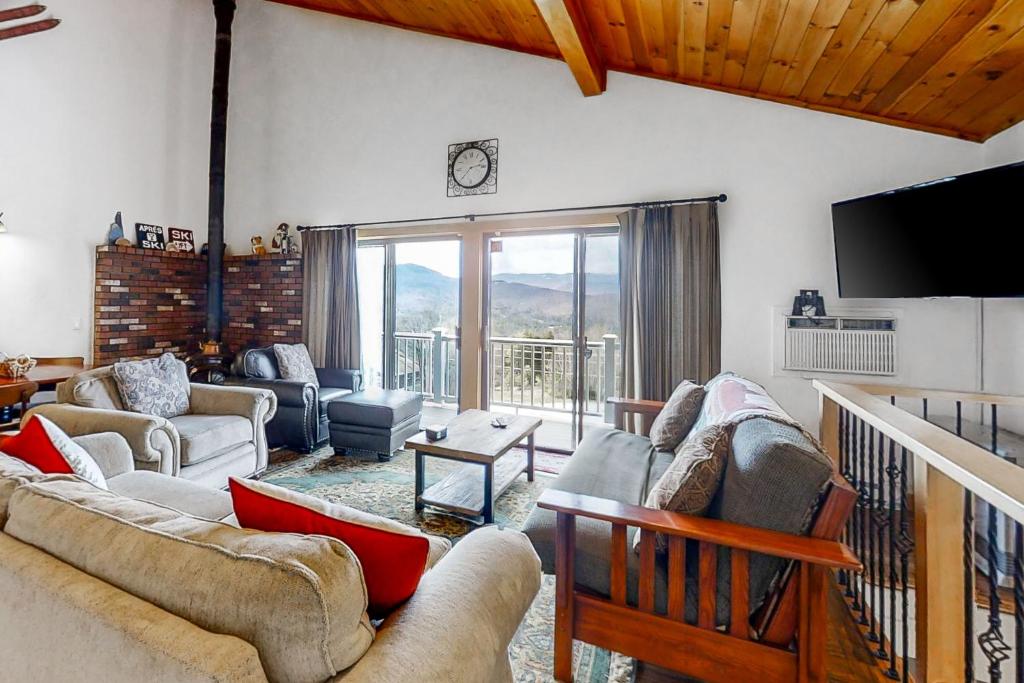 a living room with couches and a flat screen tv at Linderhof Mountainside 12 in Bartlett