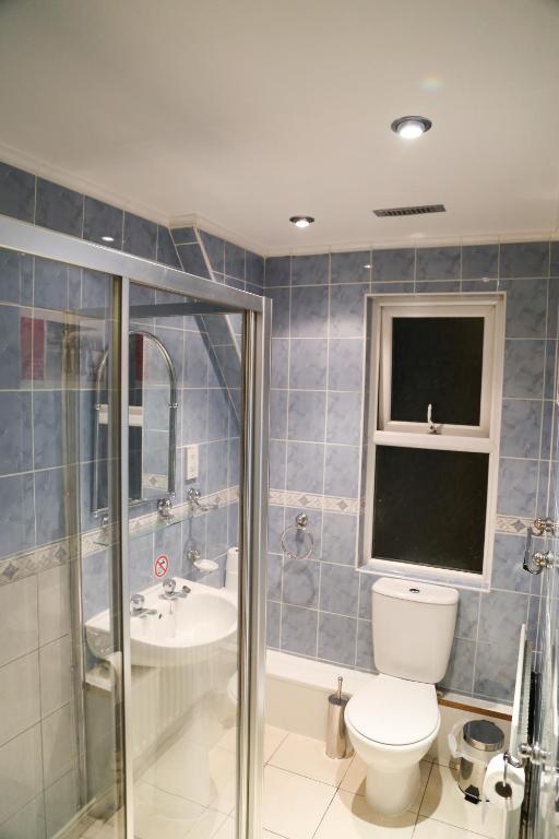 a bathroom with a toilet and a sink and a shower at Croft Hotel in Leicester
