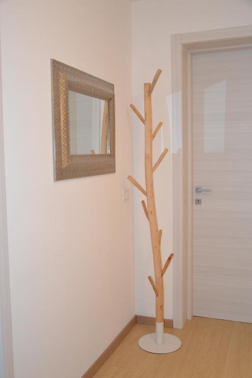 a fake tree in a room with a mirror at Casa Annadelia in Silvi Paese