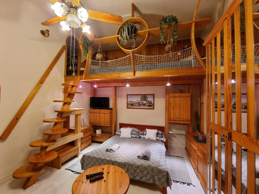- une chambre avec un lit et un escalier en colimaçon dans l'établissement Little Cozy Apartman, à Miskolc