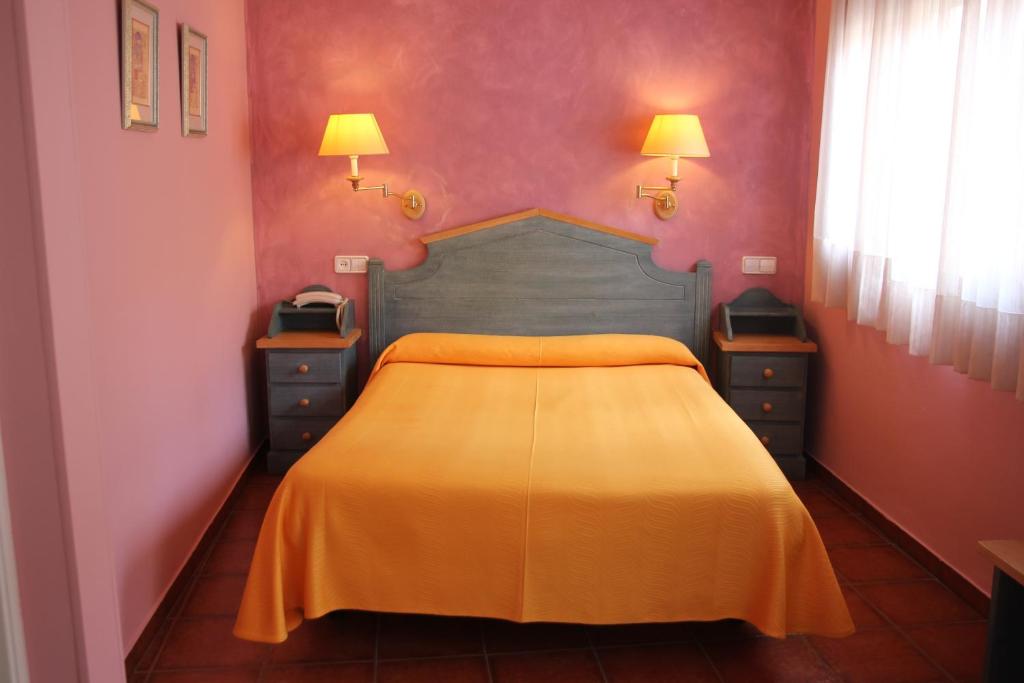 Postel nebo postele na pokoji v ubytování Hotel Fray Tomás