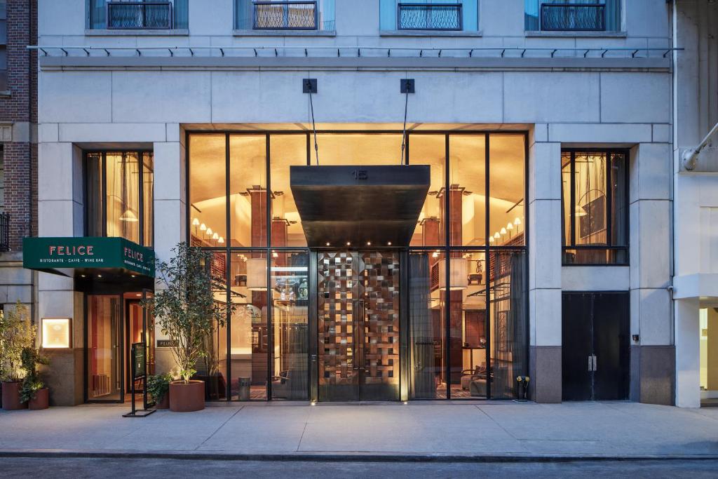 a facade of a building with a large glass door at Sonder Chambers in New York