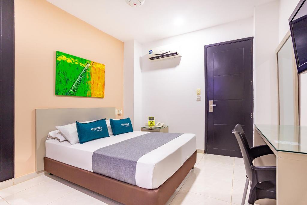 Postel nebo postele na pokoji v ubytování Hotel Ayenda Monteria Central