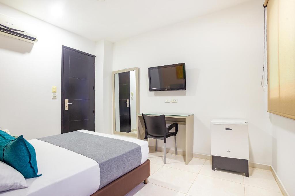Postel nebo postele na pokoji v ubytování Hotel Ayenda Monteria Central