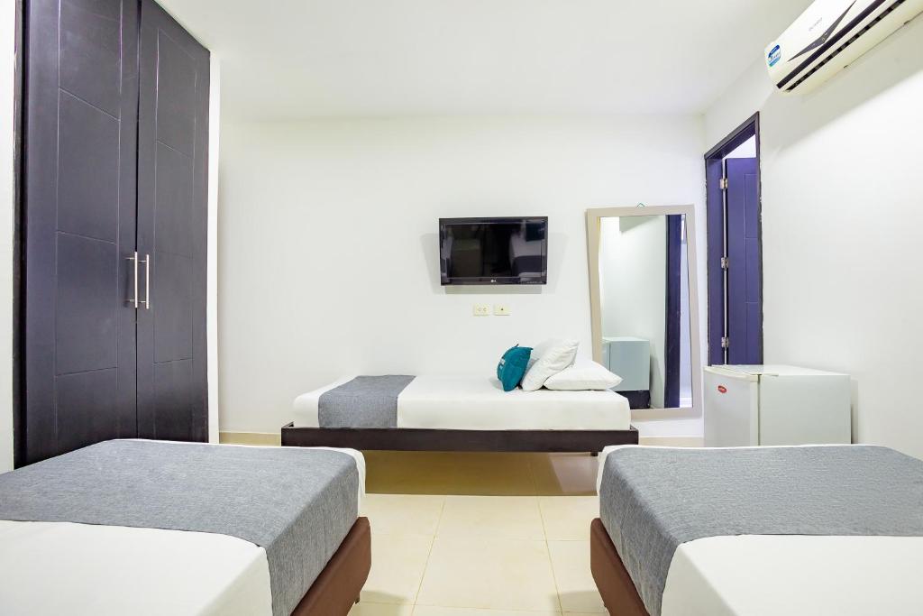 TV a/nebo společenská místnost v ubytování Hotel Ayenda Monteria Central